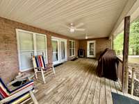 Covered Deck with nice deck; Primary Suite door opens onto the deck. After relaxing on the deck, enter thru the Living Room double doors and relax by the gas log fireplace