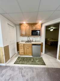 Basement has kitchenette and multi purpose closet; Tile in kitchenette area; Flows into 2 bedrooms and 1 bath with large Living/Den area