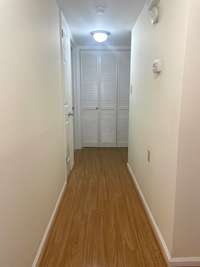 Hallway to bedroom and bathroom with laundry room at end of the hall