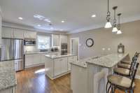 Kitchen with white cabinetry, granite, and stainless appliances