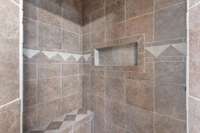 Oversized fully tiled walk in shower.