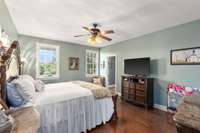 Primary suite on the main floor has beautiful windows allowing natural light to flood the room.