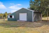 Additional worksop with 2 horse stalls as the entire property is fenced in and ready for you to bring your horses. Workshop has utilities.
