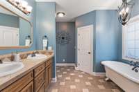 The size of this primary bathroom allows 2 to easily prepare for the day at the same time, comfortably.