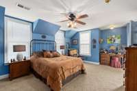 One of the 3 bedrooms on the second floor offering a large space that even allows for a desk.
