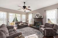 This family room centers itself around an oversized hearth with a warm wood mantle that draws your eye to this beautiful focal point. One also has direct access to the back porch though the sliding glass doors on the far wall of the room.