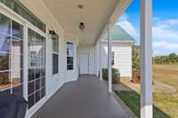 The covered back porch inviting you to sit and have a glass of ice tea while you read a book or sit with a friend chatting about your day.