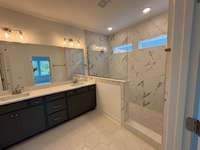 Super shower with beautiful tile work in owner's bath.