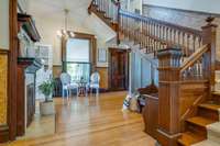 The wrap around side porch leads to the rear vestibule complete with cozy fireplace and stunning original stairway.