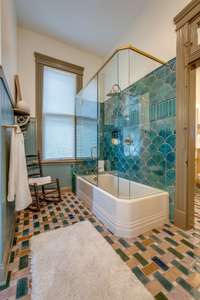 Main level full bath features stunning artisan tile work