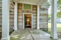 Covered walkway from the main house leads to this adorable guest cottage