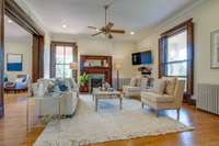 To the right of the entry parlor, this elegant living room features this handsome fireplace and two sets of pocket doors which were restored to glide smoothly segmenting room to room - perfect for entertaining.