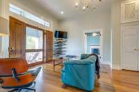 Upstairs sitting room/den with two storage closets and doorway leading to upstairs covered porch.