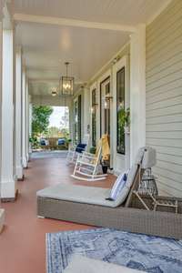 Beautiful views of the abundant fruit and hardwood trees can be enjoyed on the enormous elegant front porch.