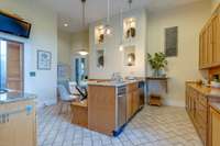 The pantry is to the left and the doorway in the back left leads to an additional mudroom and laundry room.