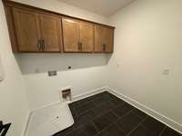 Huge laundry room with upgraded cabinets.