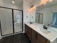 Owner's bath with large walk in shower.