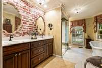 large primary bath with tile, zero-entry shower and soaking tub