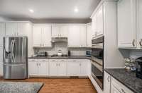 New tile backsplash. Gas stovetop and new refrigerator!