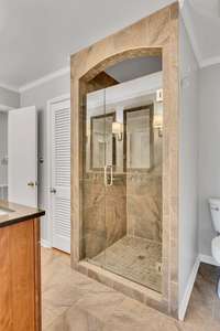 Updated second bathroom features a large walk-in tile shower, and double vanities.