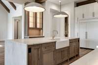 Chef Kitchen with wood beams, custom cabinetry, quartzite countertops and state-of-the-art appliances.