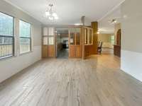 Looking from the dining room towards the kitchen, you can also see the den on the right.