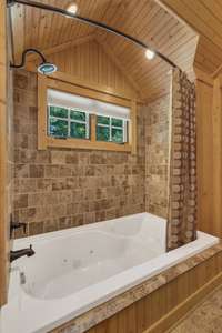 The attention to detail in this space is outstanding.  Just look at the combination of materials used in the tub/shower combination surround.  Completely unique and stunning.