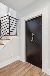 Vault door leads to a secure built-in safe room / tornado shelter