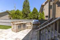 Bar sitting area, grill, and dedicated space for a Green Egg smoker