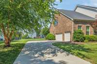 The concrete driveway offers plenty of parking space for guests.