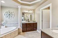 The primary bath features two vanities, a garden tub, walk-in shower and two walk-in closets.