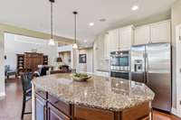 This remarkable kitchen features built-in appliances, hardwood flooring, recessed lighting, and is open to the living room.