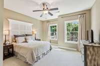 The fourth bedroom features a ceiling fan and private bath.