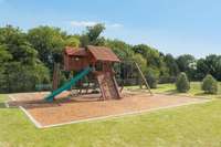 The playground is located next to the pool.