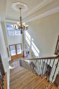 ENTRY STAIRS VIEW FROM 2ND FLOOR HALL TOWARDS FRONT ENTRY