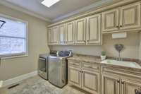 LAUNDRY ROOM WITH CABINETS AND SINK