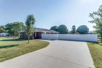 Ample parking for guests on this concrete driveway and parking pad.