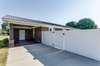 This photo shows the carport and the gate to the backyard.