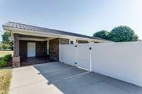 This photo shows the carport and the gate to the backyard.