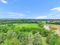 Back 10 acres of lush, cleared pastureland. Could be subdivided and sold off. Or build additional dwelling on the soil site.