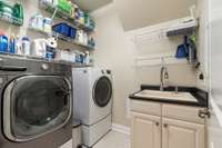 Laundry room with sink and shelving for maximum use.