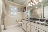 Second full bath upstairs with double vanity, tile surround shower.