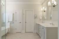 This primary bath is absolutely stunning with Cambia quartz, custom built vanity and Victoria and Albert clawfoot tub.