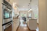 Truly, a chef's kitchen featuring double ovens, gas cook top, plenty of prep space and lighting.