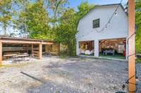 The outdoor space offers even more opportunities for relaxation and entertainment, featuring carports currently in use as outdoor dining and gathering areas.