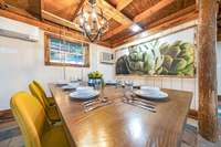 This roomy dining space, with its exposed wood beams and contemporary lighting, is where memories are made.