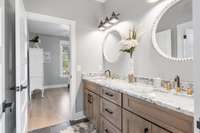 Spacious Jack & Jill Bathroom with custom cabinets to match the home and beautiful granite countertops!