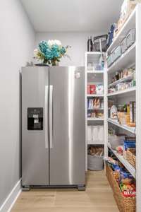 Additional Refrigerator is also housed in the pantry. Pantry even has custom wood shelving!