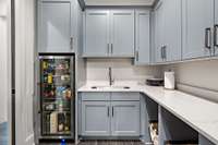 Laundry room with refrigerator located off "her" bedroom closet