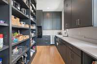 Oversized pantry with wine fridge and custom pull out cabinets